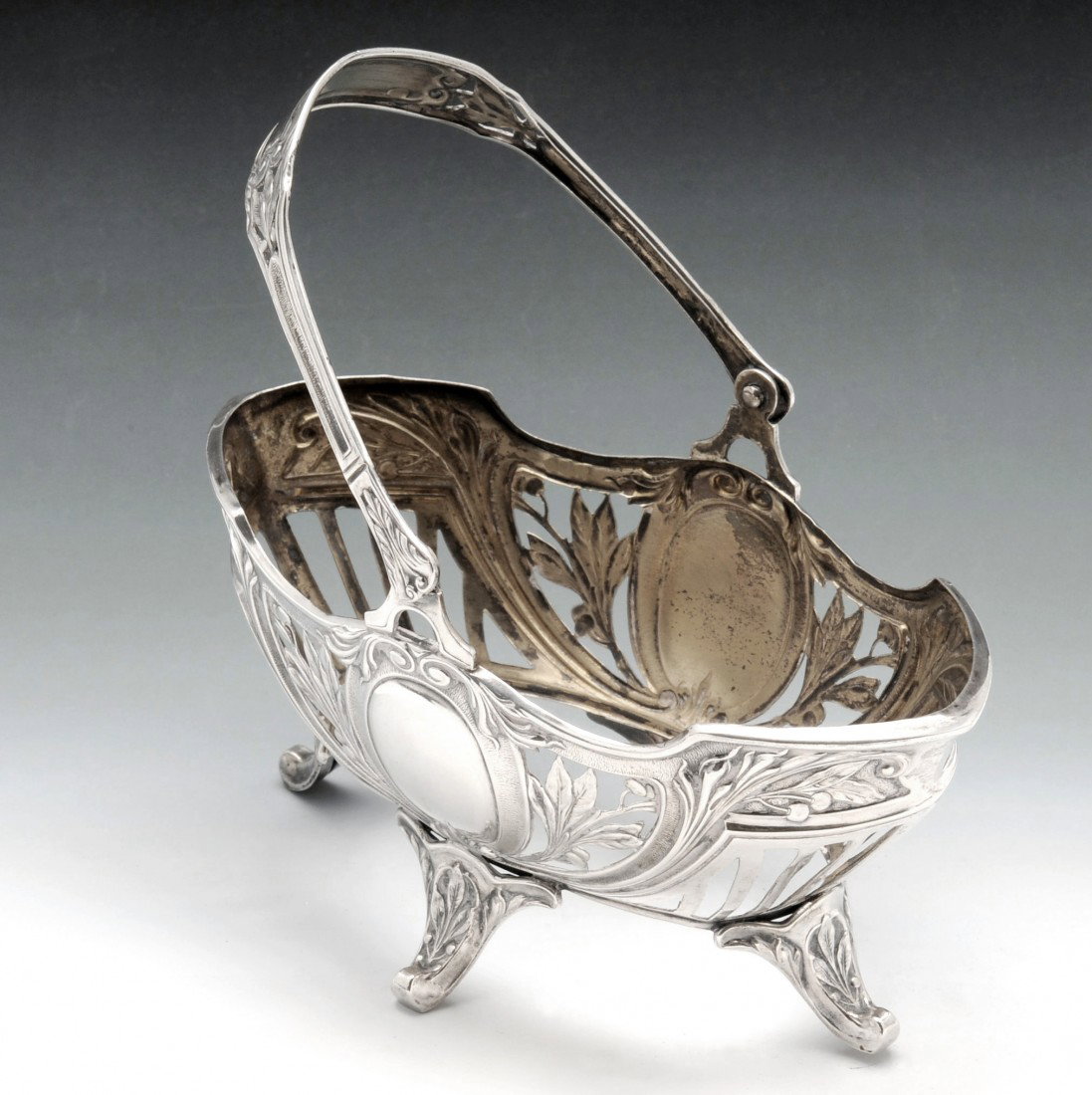 German sweet meat basket.: German sweet meat basket of oval open work form with swing handle, missing liner. Marked with the standard of 800 and the national crescent moon and crown mark, the maker possibly Lutz & Weiss. Maximu