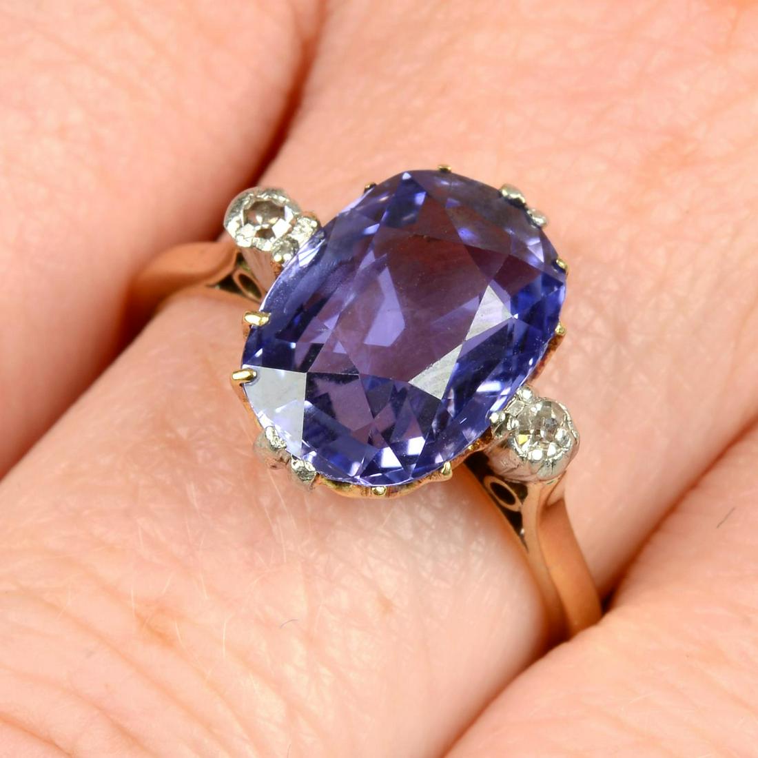 A Sri Lankan colour-change sapphire single-stone ring, with single-cut diamond sides.With report: A Sri Lankan colour-change sapphire single-stone ring, with single-cut diamond sides.With report 22043, dated 23rd August 2022, from The Gem & Pearl Laboratory, stating Sri Lanka, no heat, blue in day
