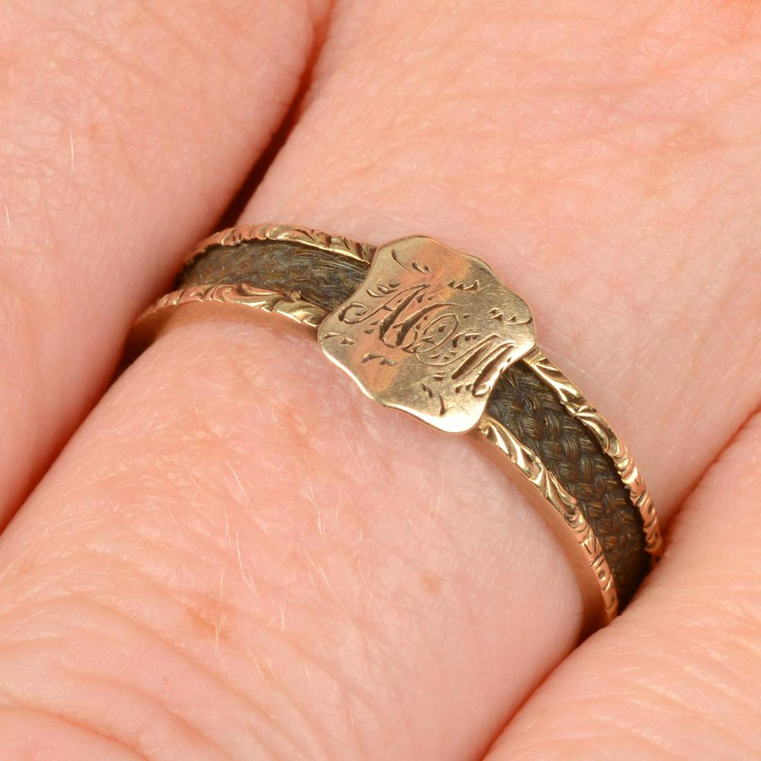 An early Victorian gold woven hair band ring, with monogram shield.Ring size O. 1.5gms. We offer (1 of 6)