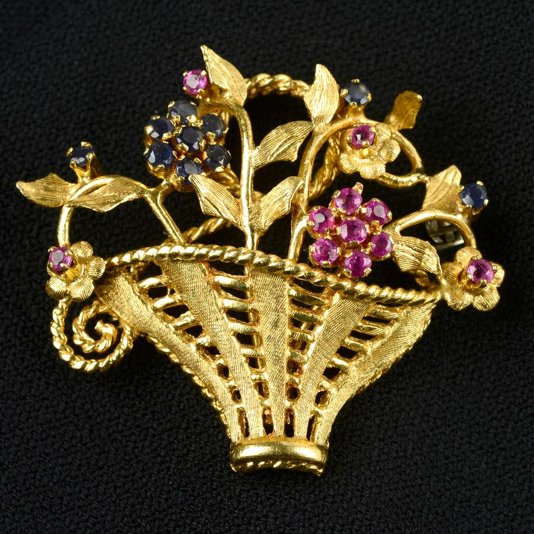 A mid 20th century 18ct gold sapphire and ruby floral basket brooch.Stamped 750. Length 4.2cms. (1 of 4)
