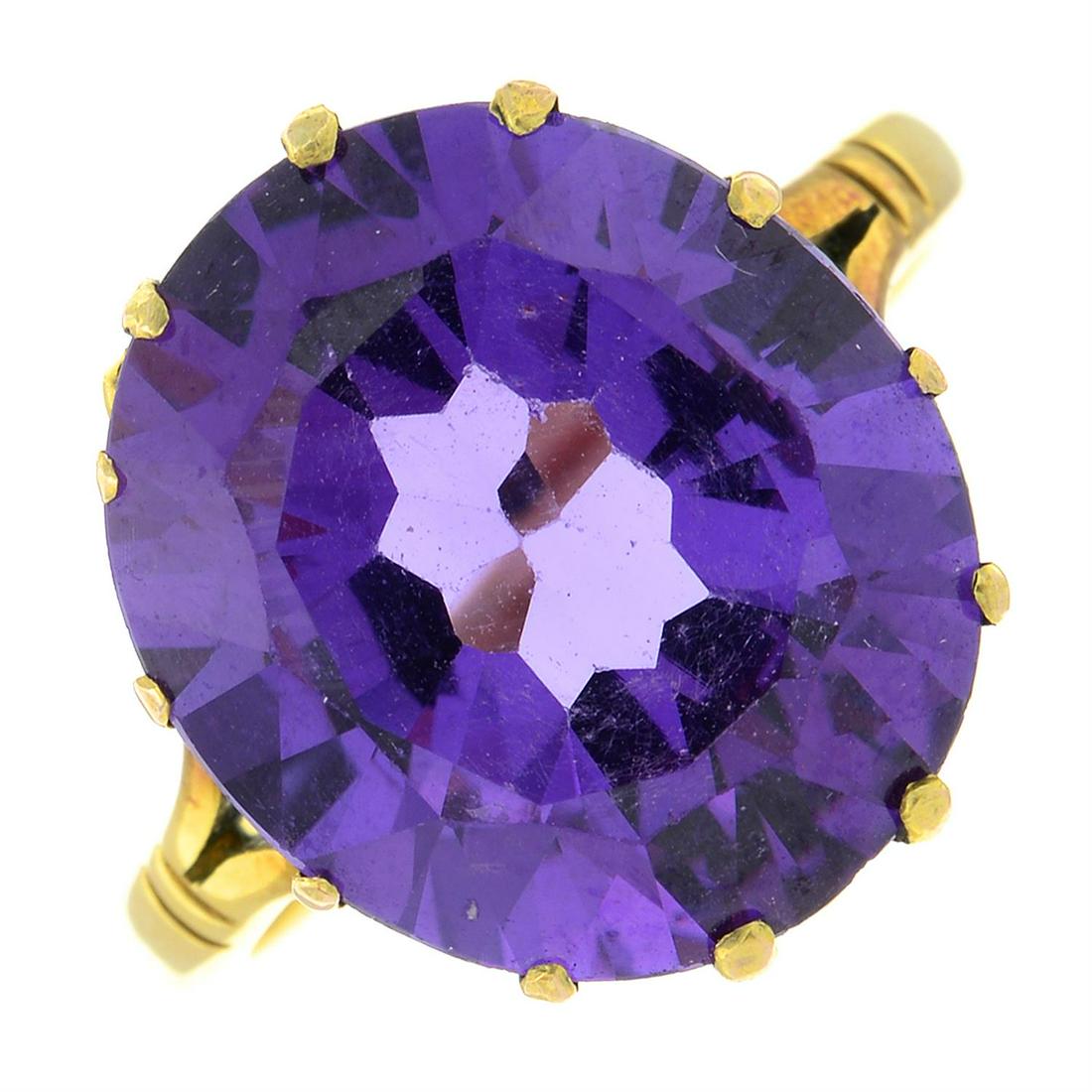 An 18ct gold synthetic colour-change sapphire single-stone ring.: An 18ct gold synthetic colour-change sapphire single-stone ring. Hallmarks for Birmingham. Ring size M. 5.3gms. Condition Report: General light marks and wear. Stone may be replacement, claws with mod