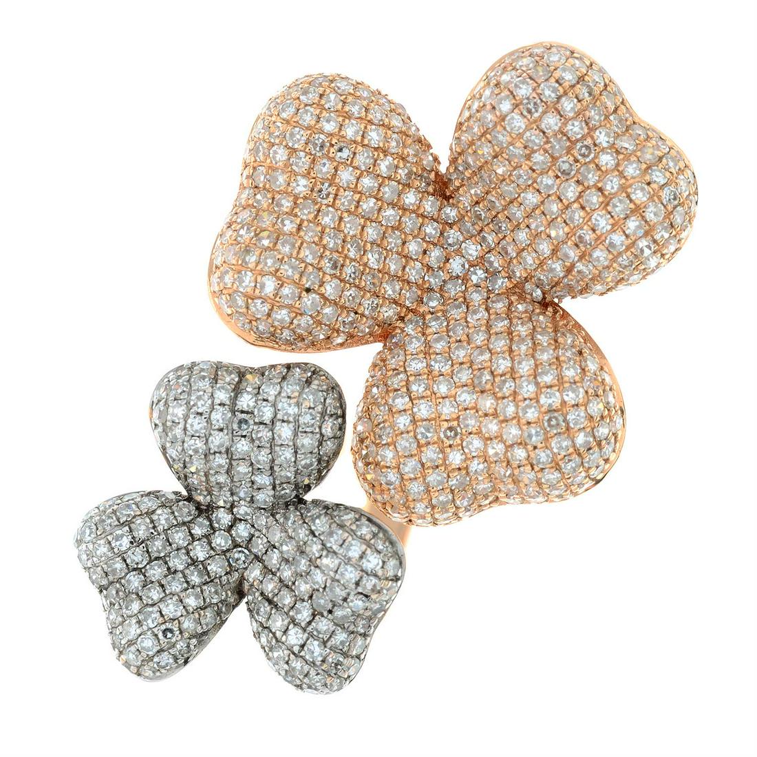 A pave-set diamond double flower ring.: A pave-set diamond double flower ring. Total diamond weight 0.36ct, stamped to mount. Stamped 750. Approximate ring size M. 6.1gms. Condition Report: General light marks. Diamond fai