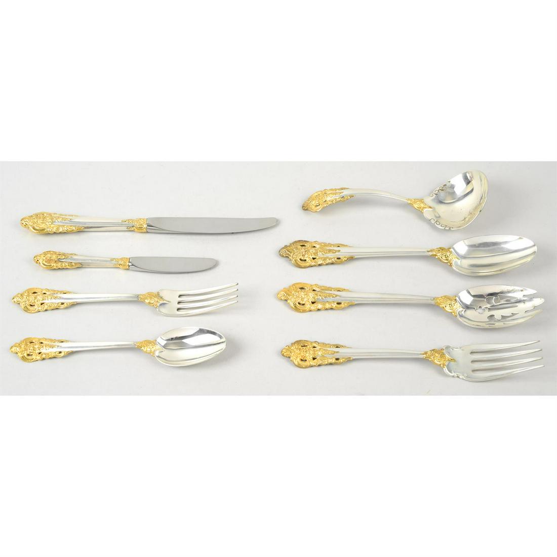 An American sterling silver canteen by Wallace Silversmiths, in Grande Baroque pattern with gilt: An American sterling silver canteen by Wallace Silversmiths, in Grande Baroque pattern with gilt accents, for twelve piece setting, comprising table knives and forks, dessert knives, forks and spoons