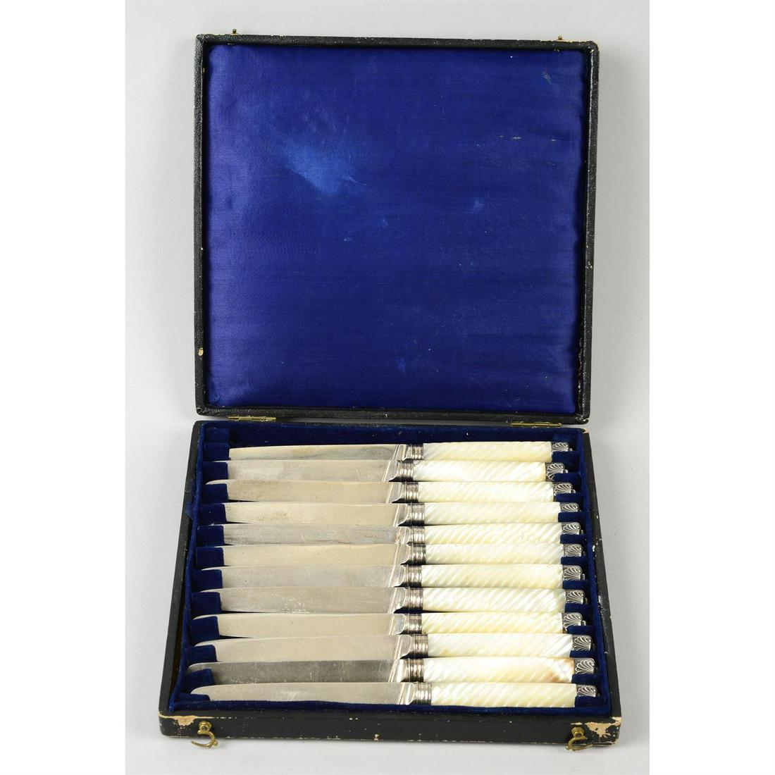 A cased composite set of twelve Georgian knives.: A cased composite set of twelve Georgian knives, having reeded mother-of-pearl mounted handles and shell moulded terminals. Hallmarked Moses Brent, London 1793/1806, and Richard Pouldon, London 1820.