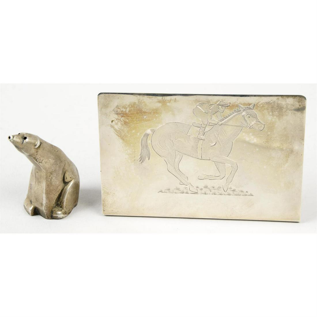 A novelty sterling silver salt/pepper pot modelled as a polar bear, by David Andersen; together: A novelty sterling silver salt/pepper pot modelled as a polar bear, stamped to base 'David Anderson Norway Sterling'. Together with a silver desk accessory with horse & jockey engraving, hallmarke
