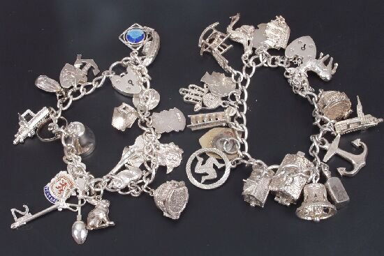 Two silver curb link bracelets, with pa: Two silver curb link bracelets, with padlock clasps suspending various assorted charms. (2)