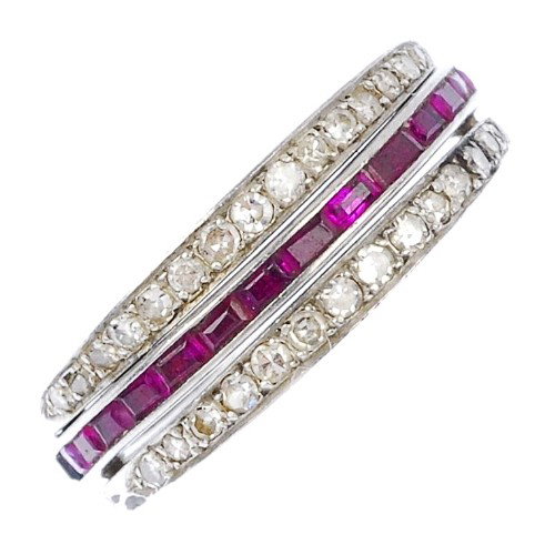 A ruby, sapphire and diamond hinged full circle ete: A ruby, sapphire and diamond hinged full circle eternity ring. The rectangular-shape ruby and sapphire line within a channel setting, to the single-cut diamond hinged half circles. One ruby deficient.