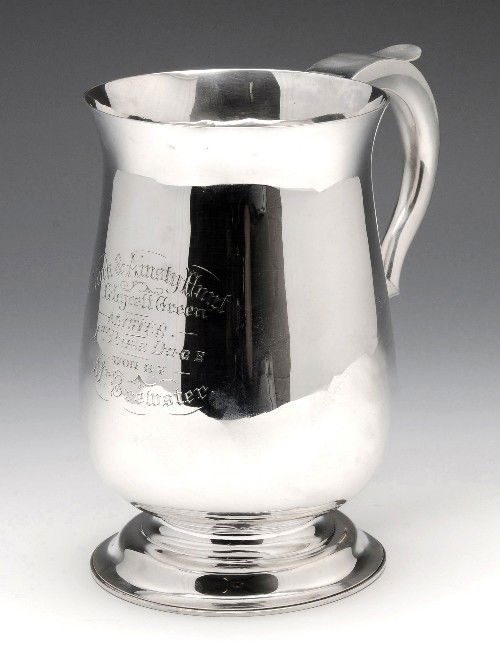 A Victorian silver two pint mug.: A Victorian silver two pint mug of baluster form, personal inscription, scrolling handle with heart from terminal and stepped circular foot. Hallmarked Charles Stuart Harris London 1887. Height measur