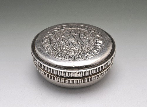 An 1940's Irish silver communion Pyx box.: An 1940's Irish silver communion Pyx box with monogram and engine turned detail to lid, ridged edges and gilded interior. Hallmarked M.H.G, Dublin, 1945. Diameter of box measuring approximately 4.8 cm