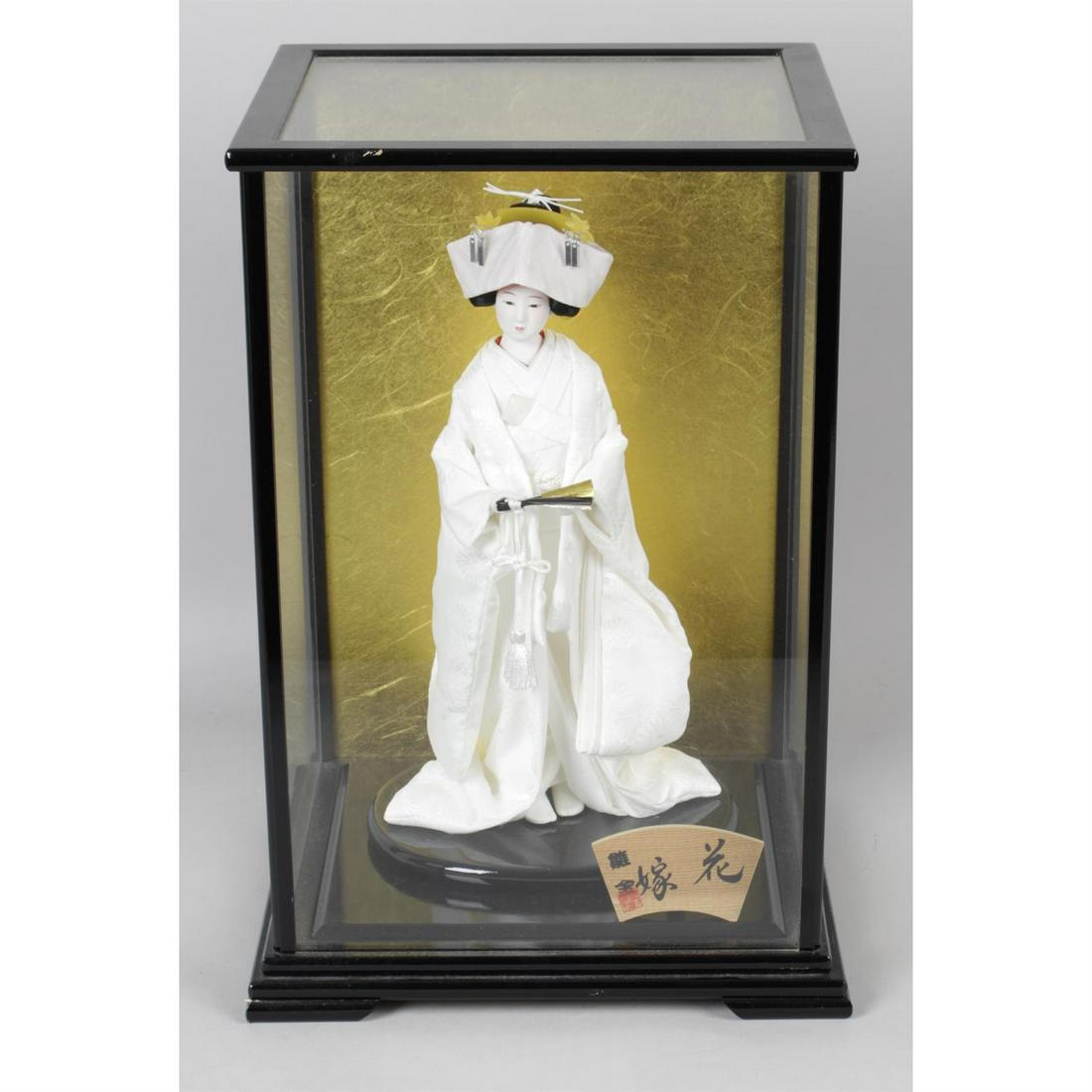 A large mixed selection of assorted costume and souvenir dolls, etc.: A large mixed selection of assorted costume and souvenir dolls, to include a selection of oriental dolls contained within a 'wall clock' case, etc. Condition Report: