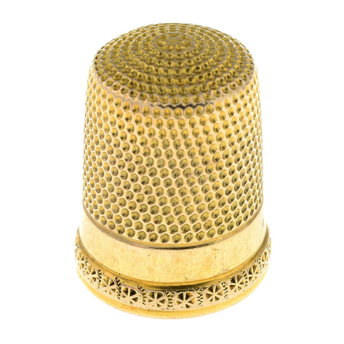 A textured thimble.: A textured thimble. Length 1.9cms. 3.3gms. Condition Report: General moderate marks and wear. Number '8"" stamped to outside of thimble. Condition reports are offered as a guide only and we highly