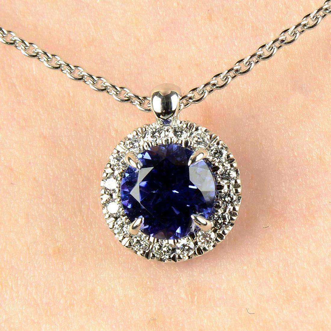 An 18ct gold tanzanite and diamond 'Joy' pendant, on chain, by Bucherer.Tanzanite weight: An 18ct gold tanzanite and diamond 'Joy' pendant, on chain, by Bucherer.Tanzanite weight 1.03cts.Total diamond weight 0.14ct, G colour, SI clarity.Swiss convention marks. Length of pendant 1.2cms. Len