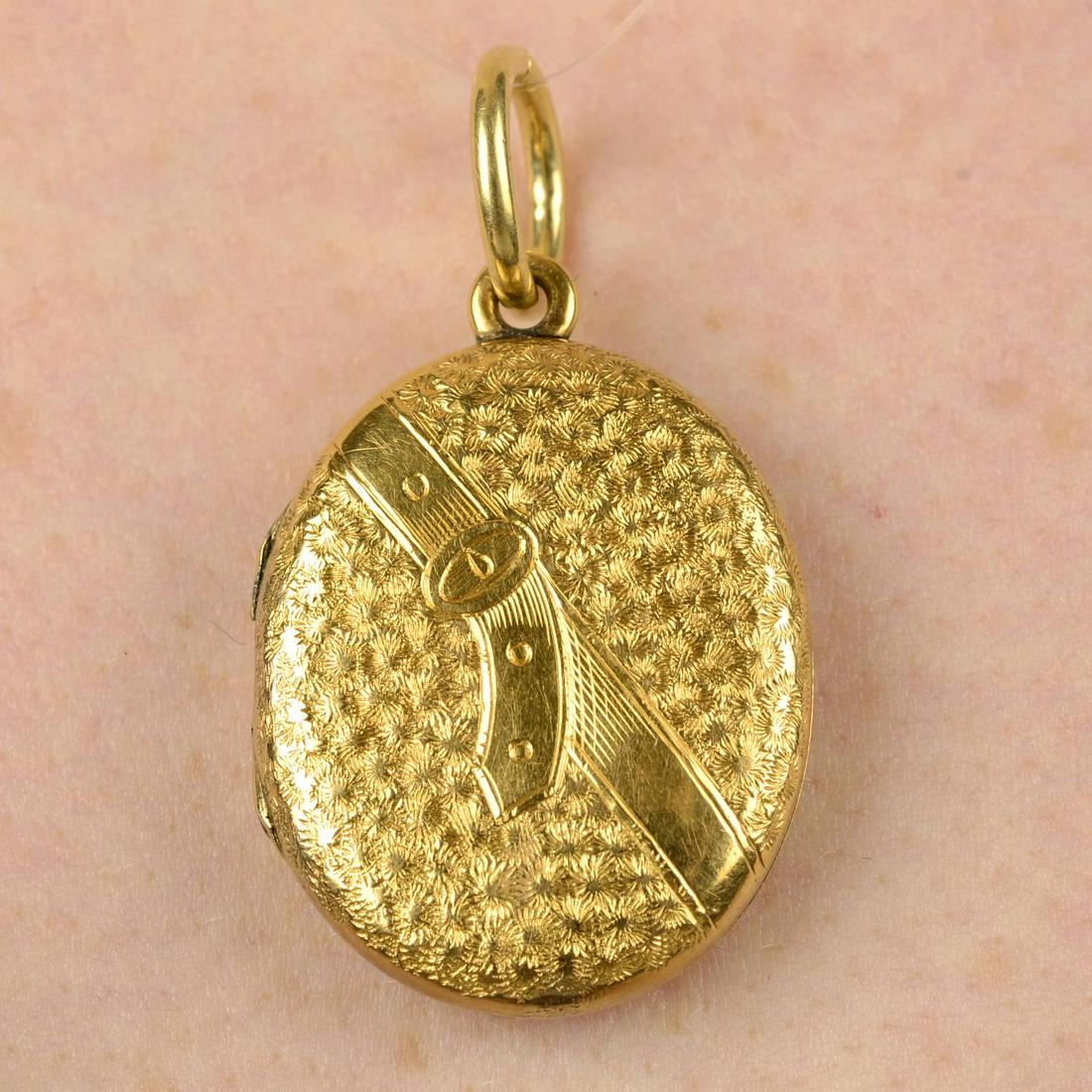 A late Victorian gold foliate and belt motif locket.Length 3.9cms. 12.2gms.: A late Victorian gold foliate and belt motif locket.Length 3.9cms. 12.2gms.