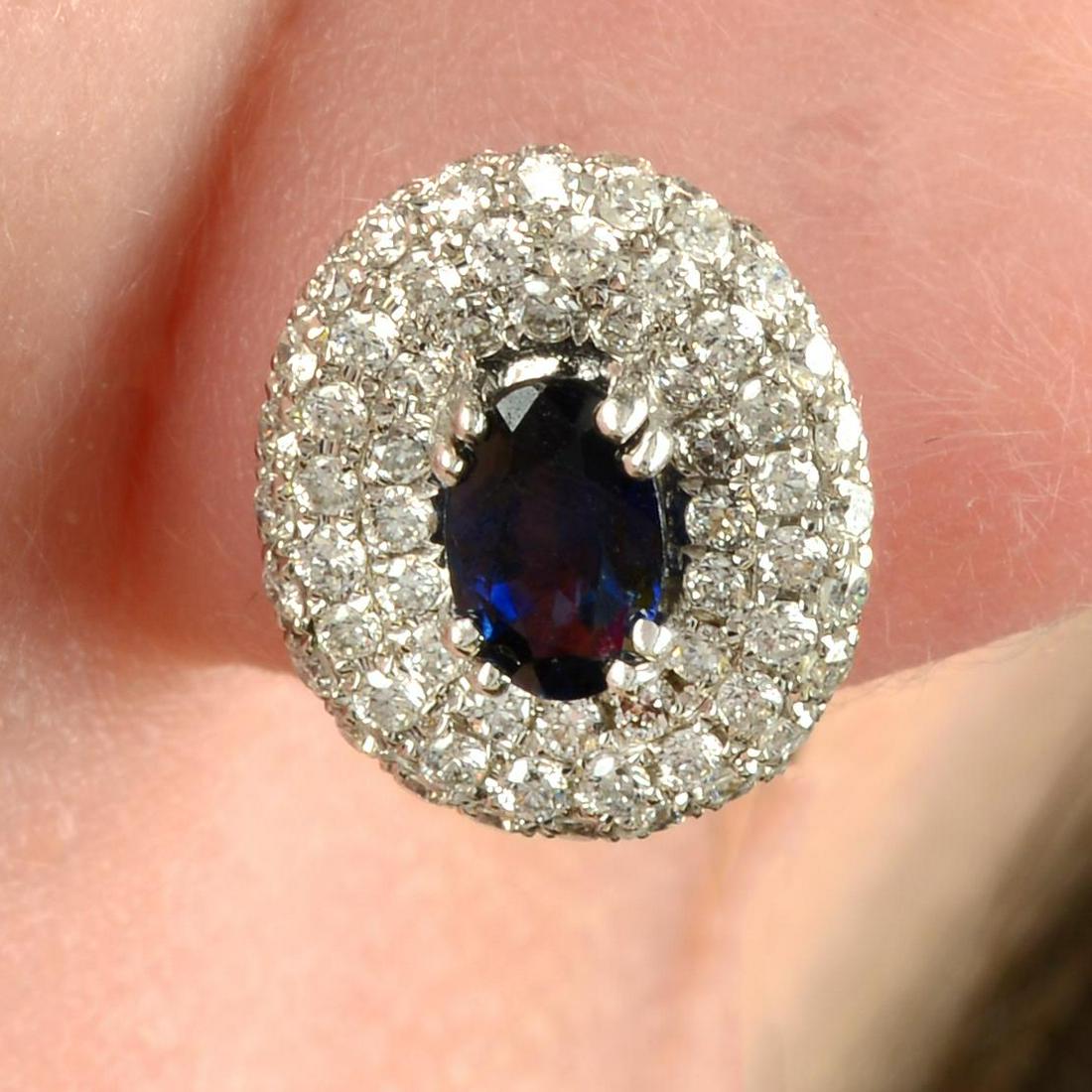 A pair of sapphire and pavÃ©-set diamond cluster earrings.Total diamond weight 0.66ct, stamped to (1 of 4)