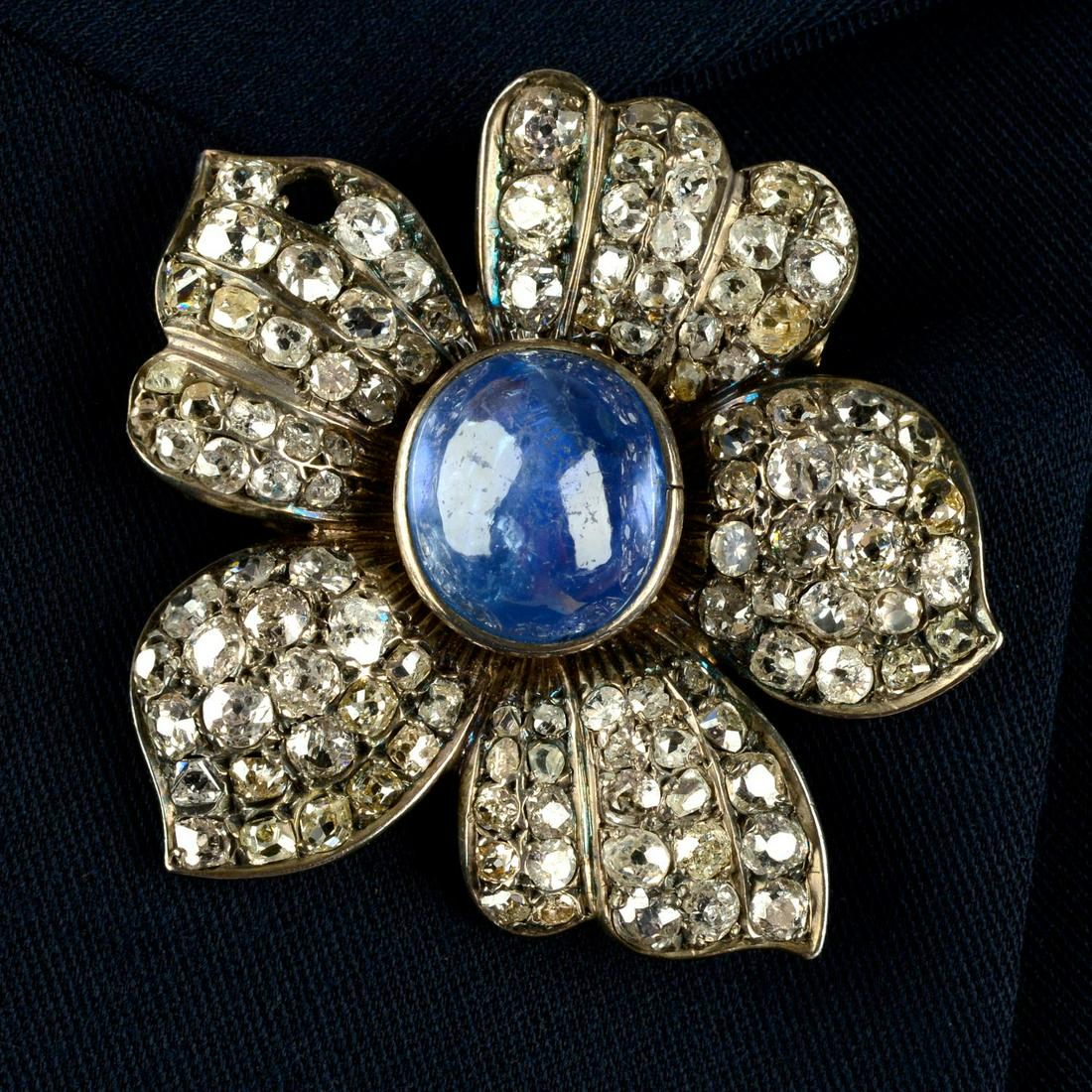 A mid 20th century silver sapphire cabochon and old-cut diamond floral brooch.Sapphire calculated (1 of 4)
