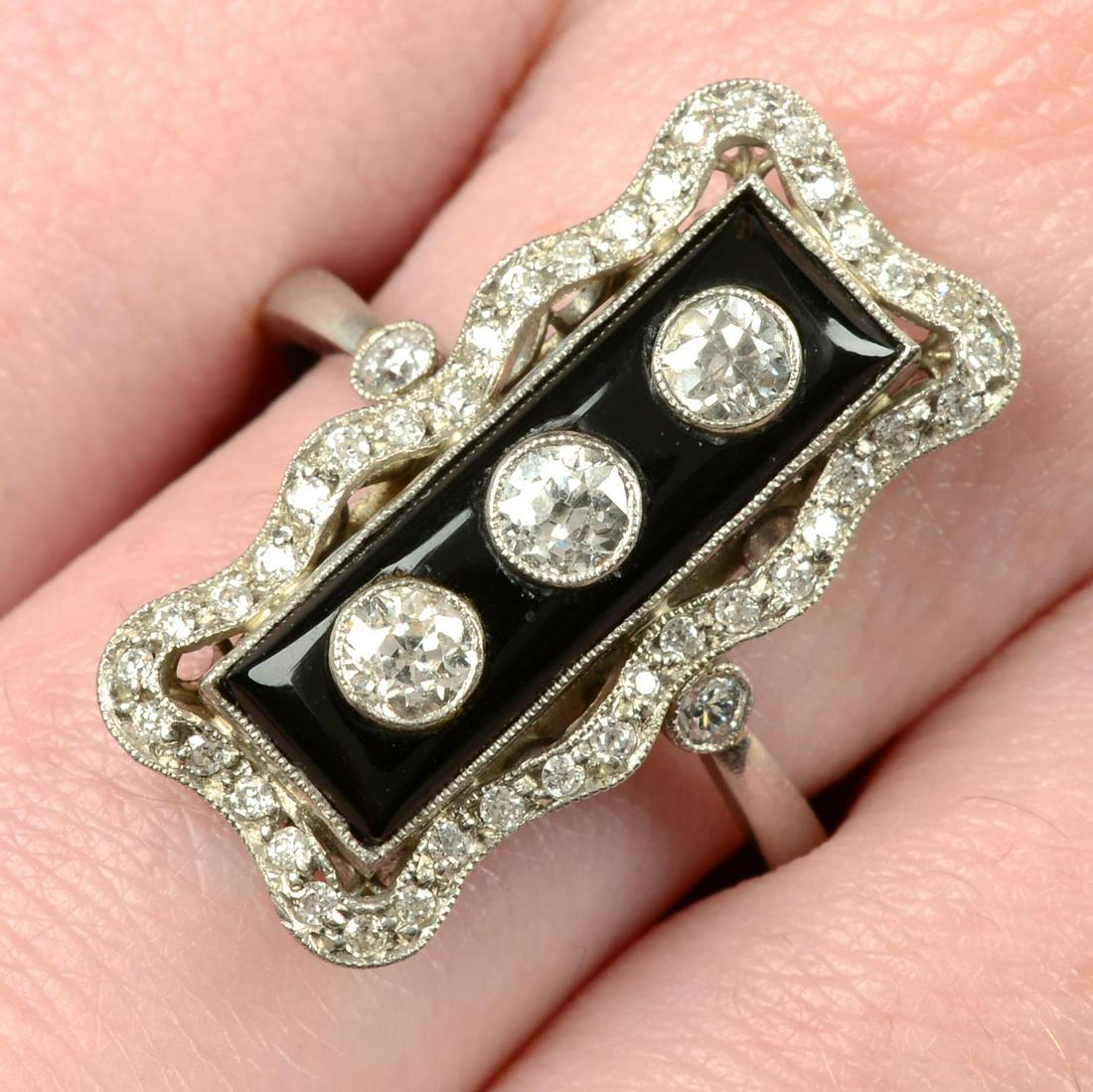 A vari-cut diamond and onyx geometric dress ring.Estimated total diamond weight 0.45ct, G-I colour, (1 of 5)