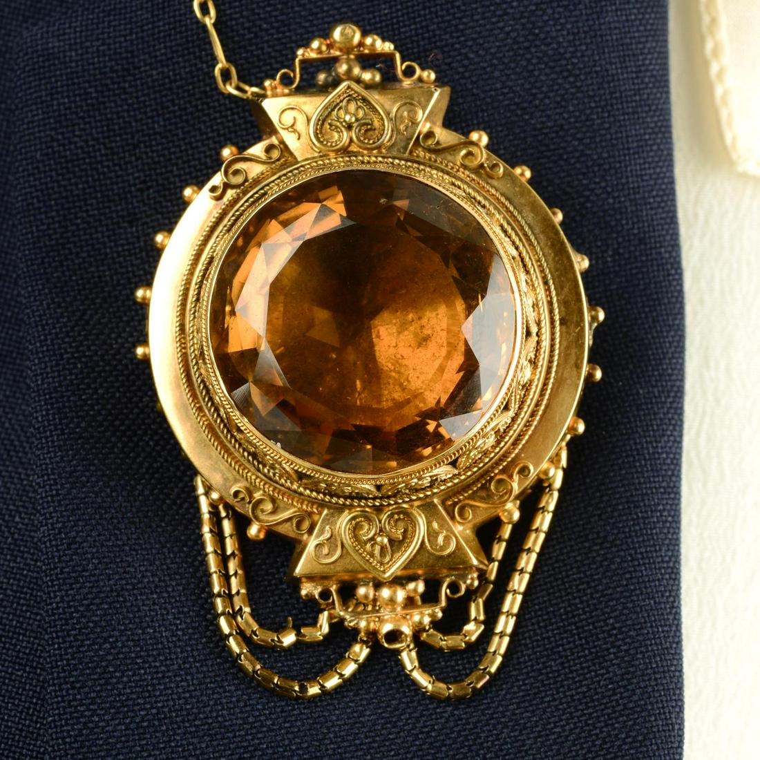 A late Victorian gold citrine cannetille brooch, with locket reverse and swags.Length 5.2cms. (1 of 6)