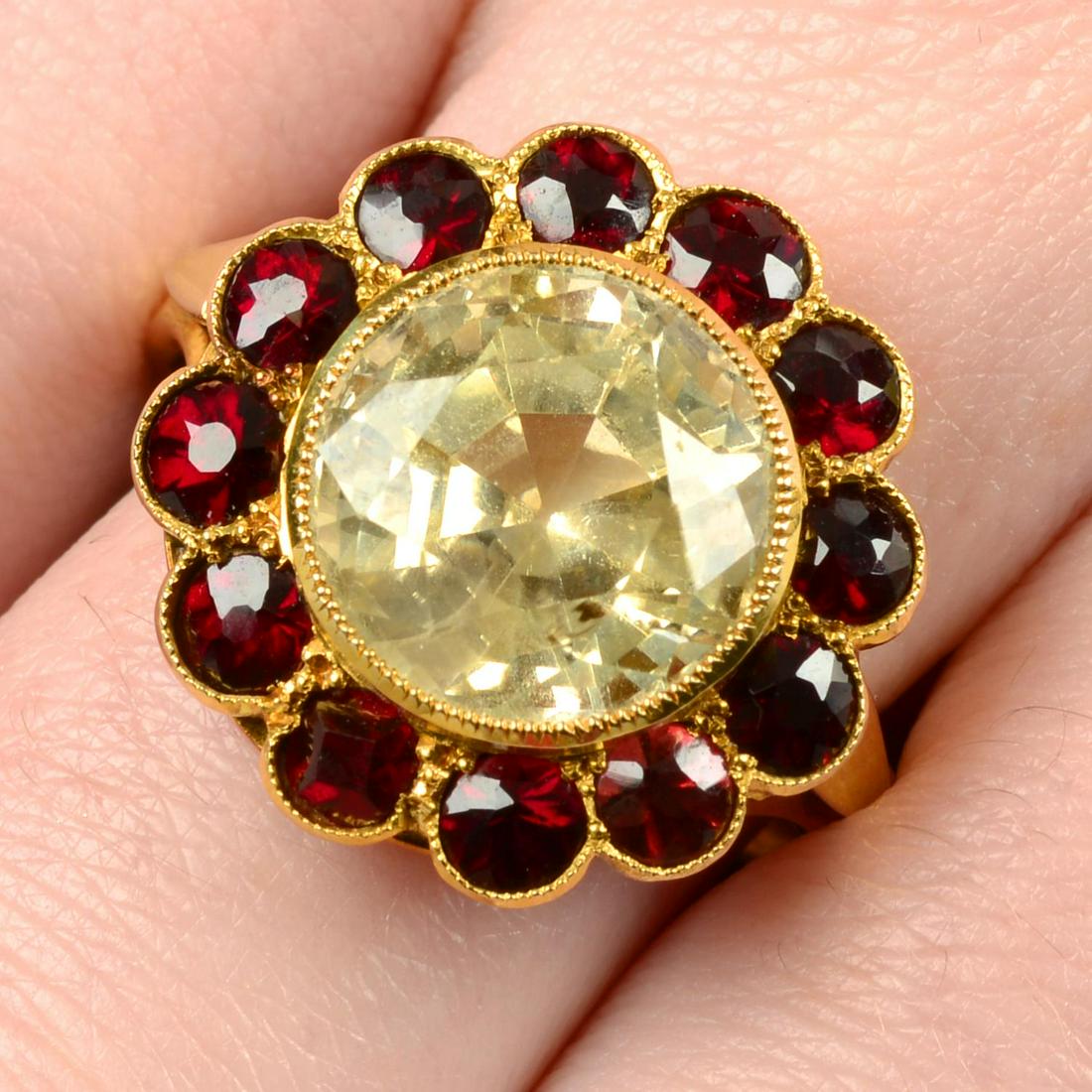 A yellow sapphire and garnet cluster ring. Sapphire calculated weight 6cts, based on estimated (1 of 5)