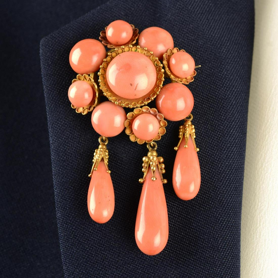 A mid to late 19th century gold coral brooch, with drop fringe.Length 6.4cms. 17.7gms.With fitted (1 of 7)