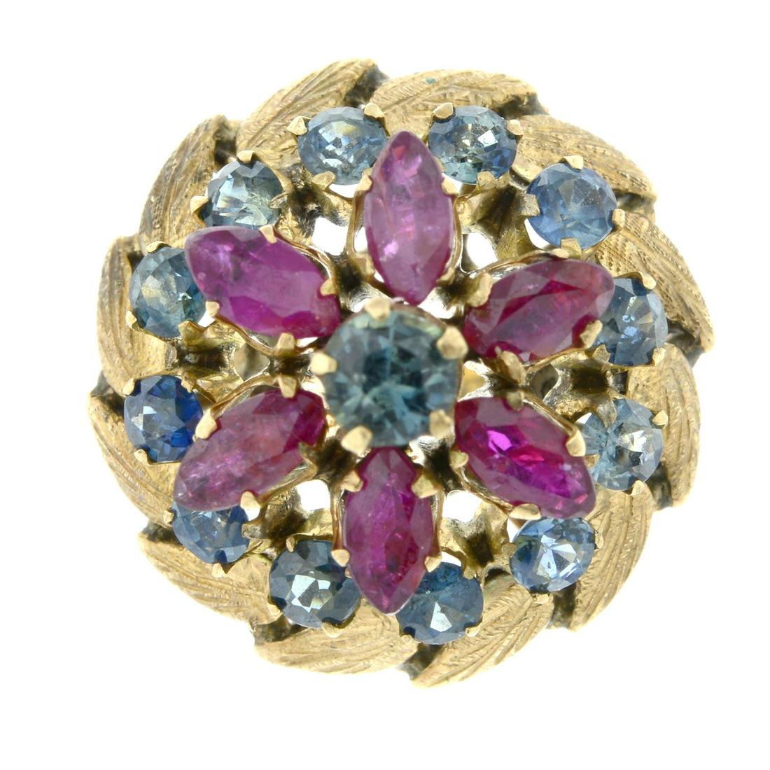 A ruby and sapphire dress ring.: A ruby and sapphire dress ring. Stamped 18k. Ring size M. 6.1gms. Condition Report: Minor surface scratches/wear in keeping with general age and wear. Height of ring head 1.6cms. Stones with minor abr