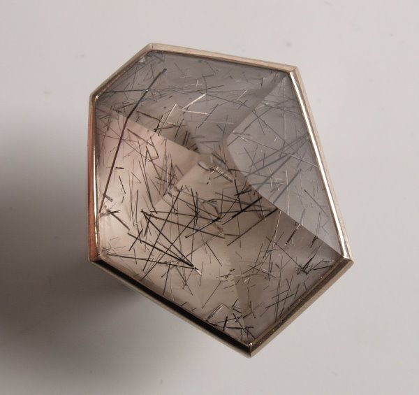 ANDREW GRIMA - 18ct white gold ring set a large r: ANDREW GRIMA - 18ct white gold ring set a large rutilated quartz stone in pyramid form - London 1973. In original box.