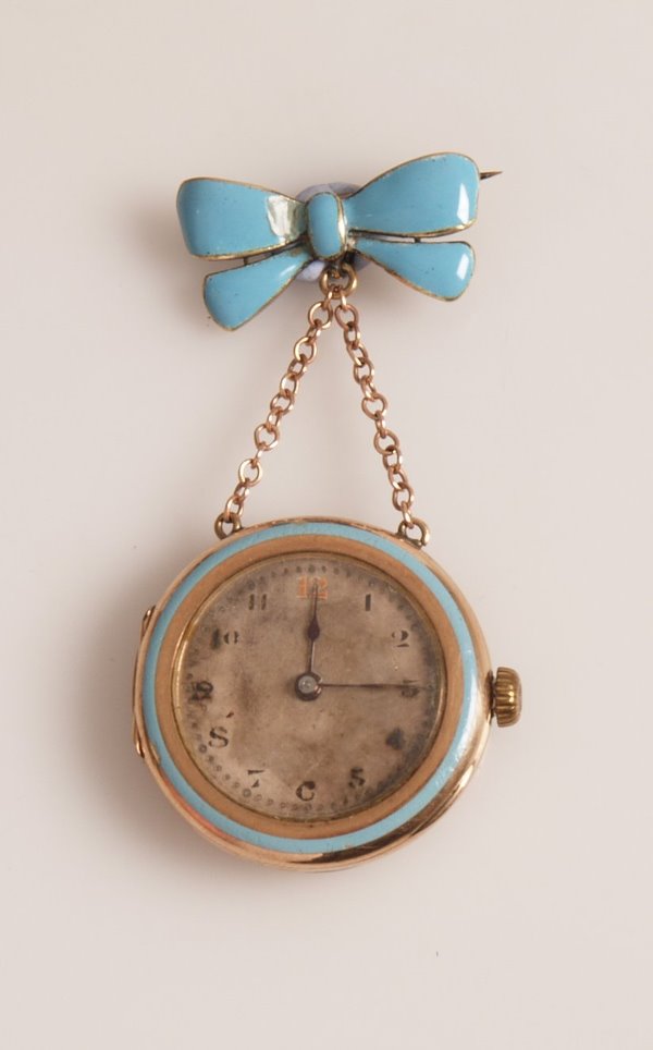 ROLEX - a George V 9ct gold fob watch with light: ROLEX - a George V 9ct gold fob watch with light blue enamel decoration to the bezel and suspended from a bow brooch fitting also in blue enamel , import marks for London 1914.