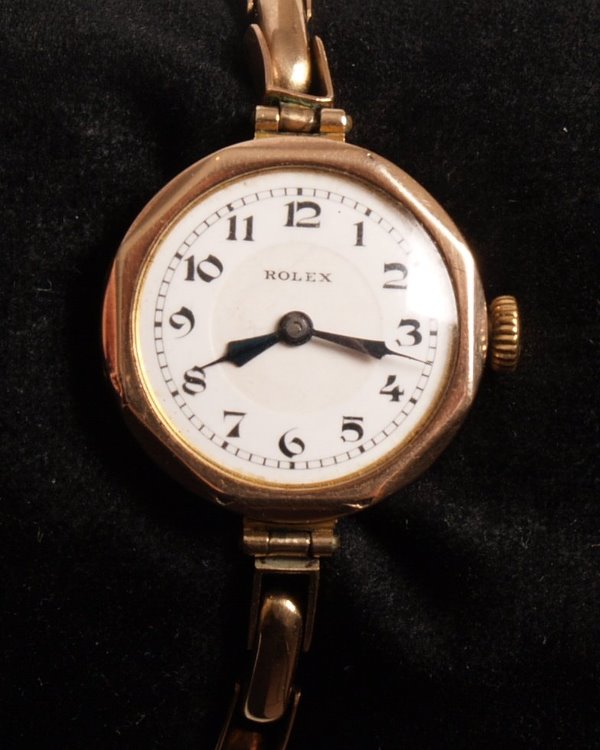 ROLEX - 1930's 9ct gold ladies watch with a shap: ROLEX - 1930's 9ct gold ladies watch with a shaped circular dial and white dial with Arabic numerals the manual wind movement marked Rolex, 15 jewels, timed six positions for all climates fitted on a