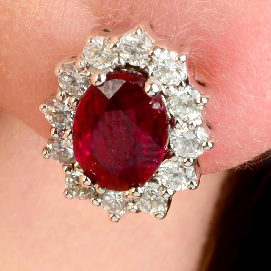 A pair of ruby and brilliant-cut diamond cluster earrings.Rubies are glass-filled.Rubies calculated (1 of 4)