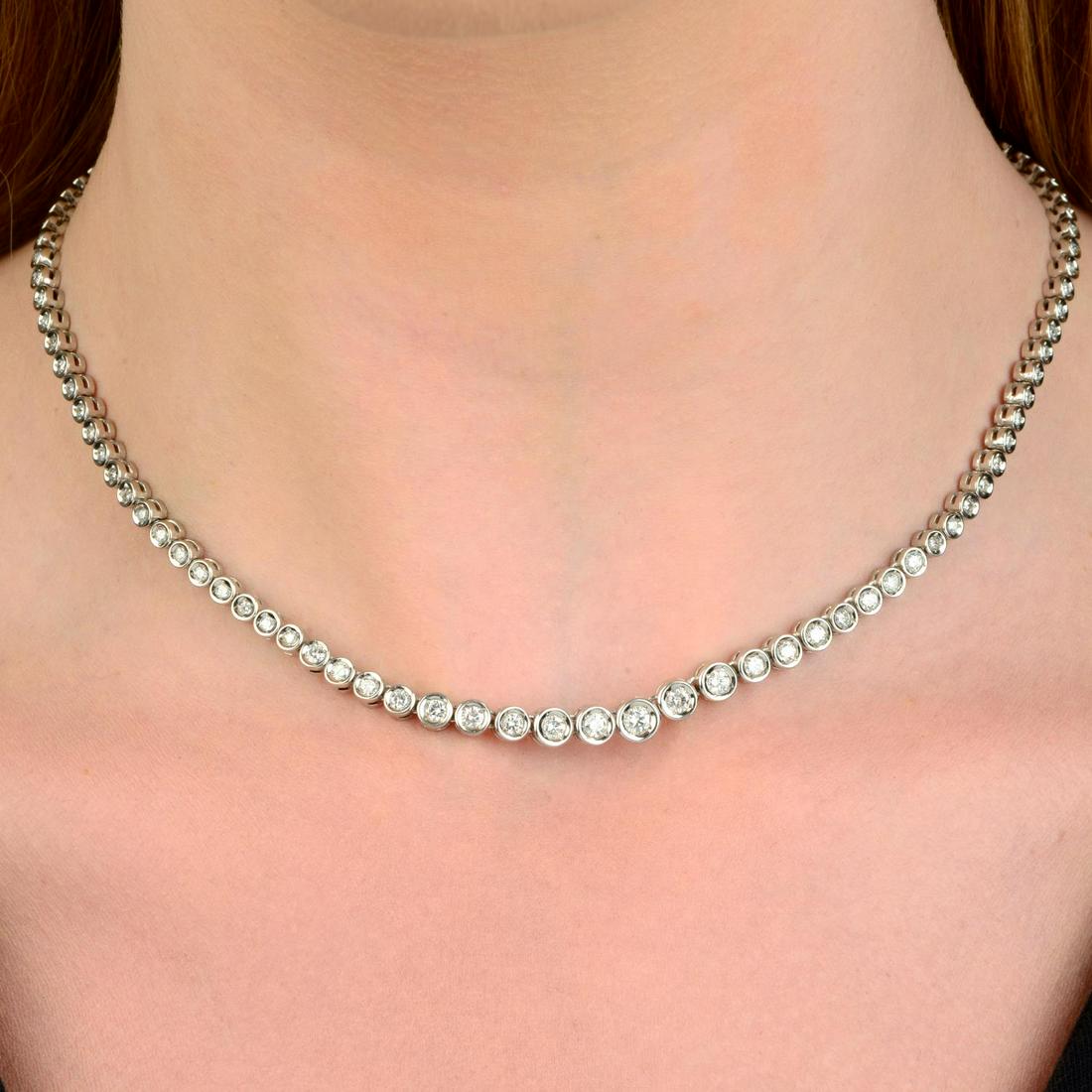 A graduated brilliant-cut diamond necklace.Total diamond weight 3cts, stamped to metal, estimated (1 of 4)