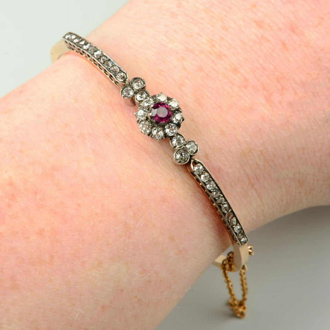 A late Victorian silver and 18ct gold, garnet old and rose-cut diamond hinged bangle.Estimated total (1 of 3)