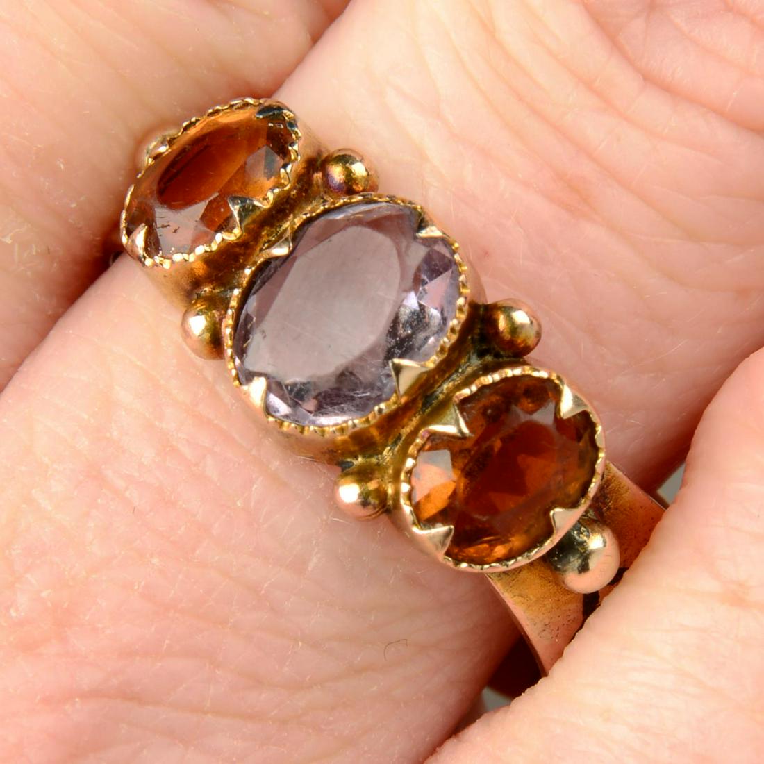 A late Victorian 9ct gold amethyst and citrine three-stone ring, the reverse of the band marked 'I (1 of 5)