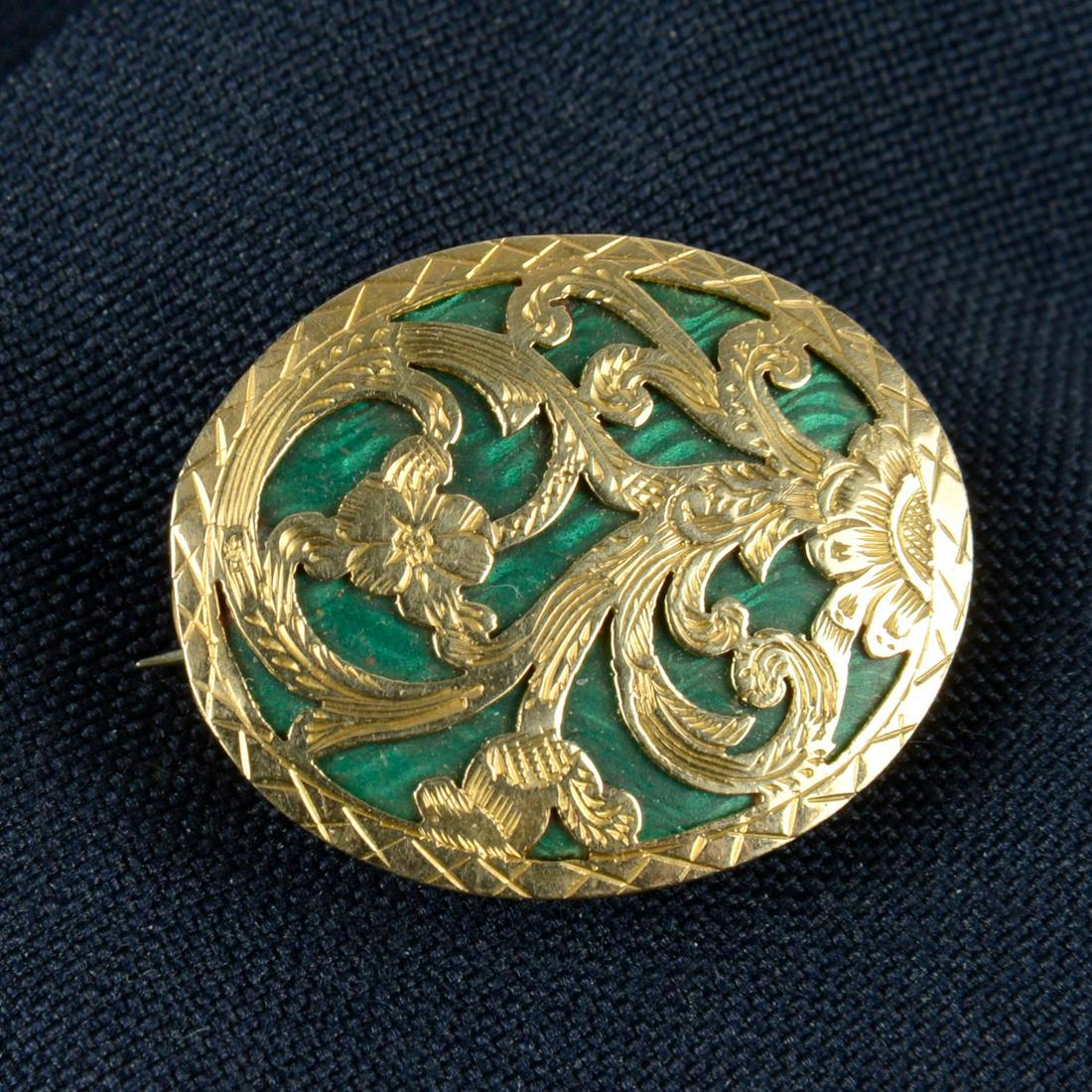 A 19th century green enamel and pierced and engraved floral lattice brooch, with glazed locket: A 19th century green enamel and pierced and engraved floral lattice brooch, with glazed locket reverse.Length 2.4cms. 5.8gms.