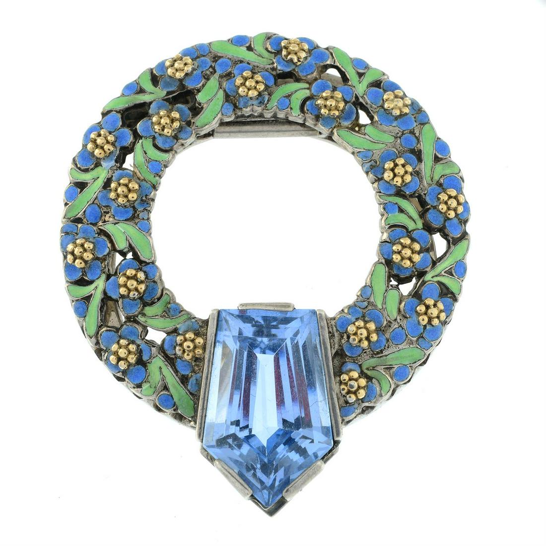 An Arts and Crafts silver blue paste and enamel wreath clip, by Bernard Instone.: An Arts and Crafts silver blue paste and enamel wreath clip, by Bernard Instone. Stamped SILVER. Length 4.7cms. 17gms. Condition Report: Enamel in good to fair condition, with one tiny damage. Blue pa