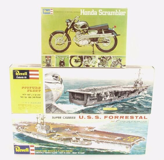 Two Revell unassembled plastic model ai: Two Revell unassembled plastic model aircraft carrier kits, and a similar motorcycle model, each in original box.