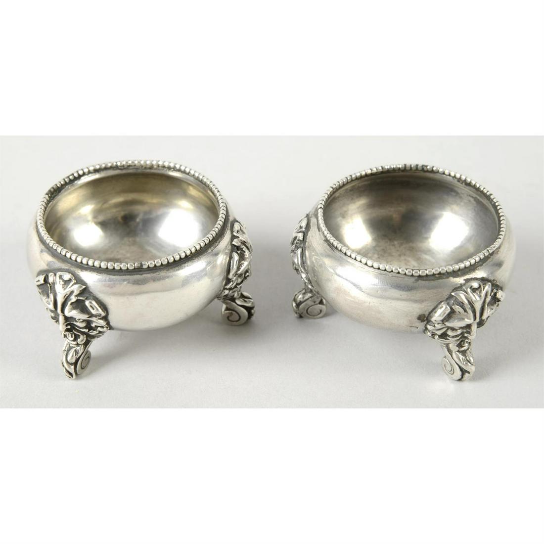 A pair of Victorian silver open salts.: A pair of Victorian silver open salts, each having beaded border and three scrolled, stepped feet with Green Man mask mounts. Hallmarked maker's mark J H, London 1876. Weight 3.27 ozt (101.8 grams). C