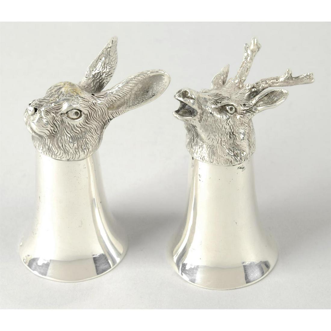 Two stirrup cups, one modelled as a stag and the other a hare.: Two stirrup cups, one modelled as a stag and the other a hare, upon plain, tapered body. Stamped with unidentified marks.Height of both approx. 3.25" (8.2cm), weight 11.67 ozt (363 grams). Condition R