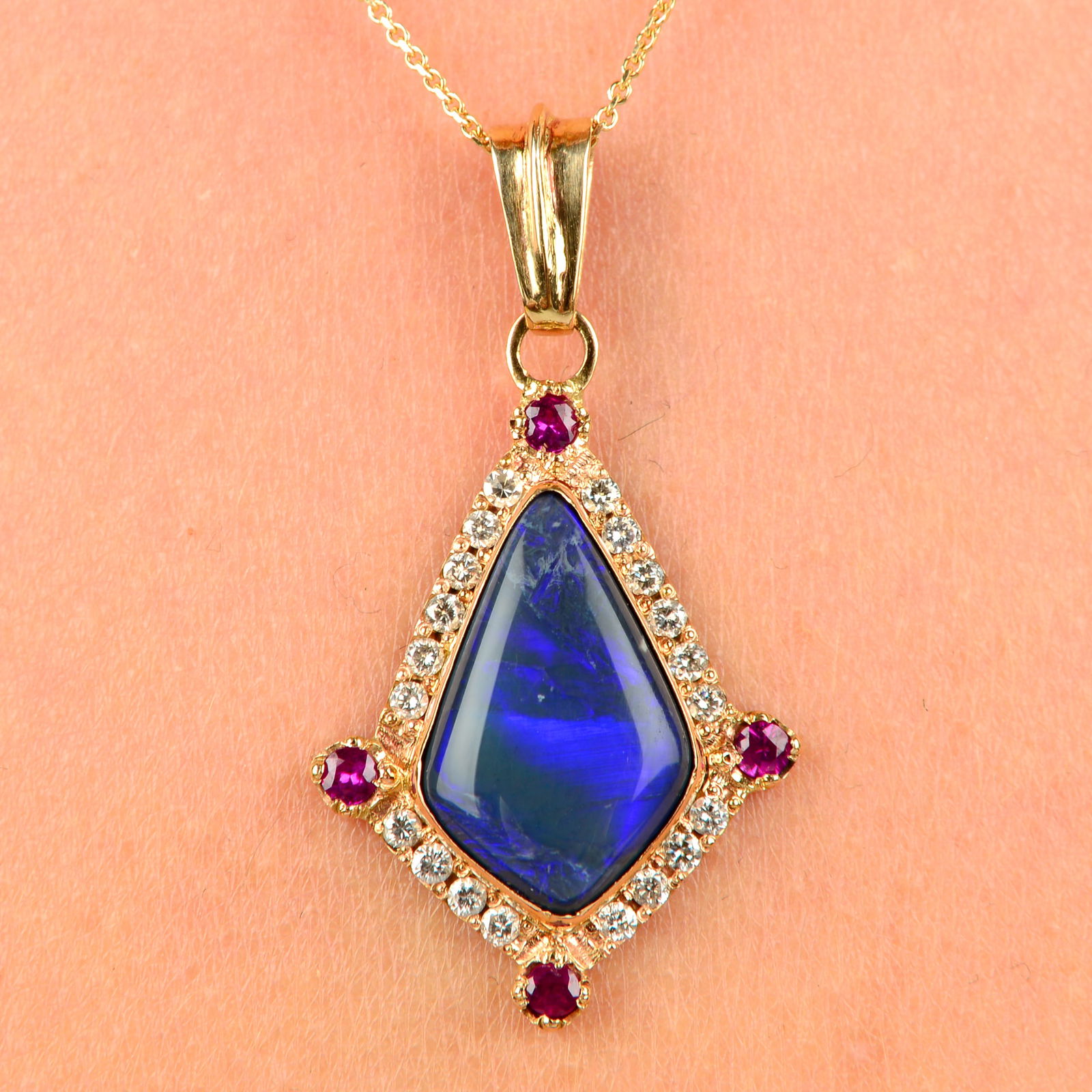 A black opal, ruby and brilliant-cut diamond pendant, with 14ct gold chain.Opal estimated dimensions (1 of 5)