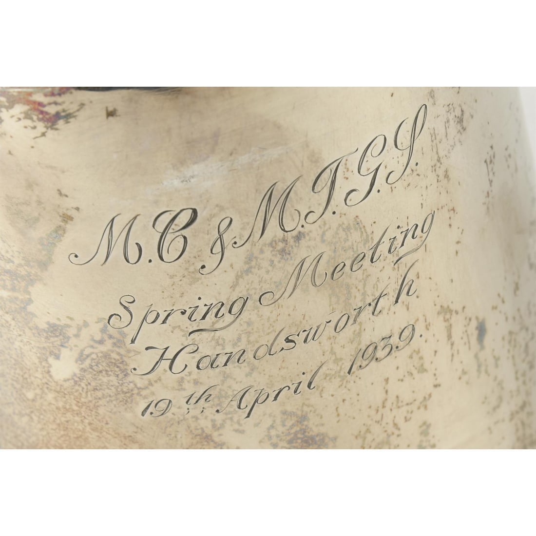 A 1930's plain silver mug.: A 1930's plain silver mug, of cylindrical form to a footed base, with simple scroll handle and personally engraved. Hallmarked William Neale & Son Ltd., Birmingham 1937. Height 4.5" (11.5cm), weight 9