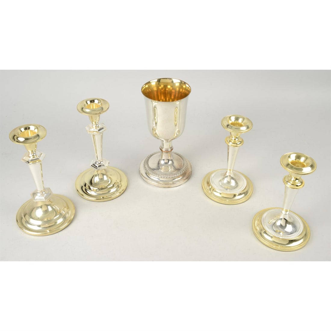 A quantity of silver plate.: A quantity of assorted silver plate to include an egg cup on stand set, goblets, candlesticks, teapots, etc (qty) Condition Report: