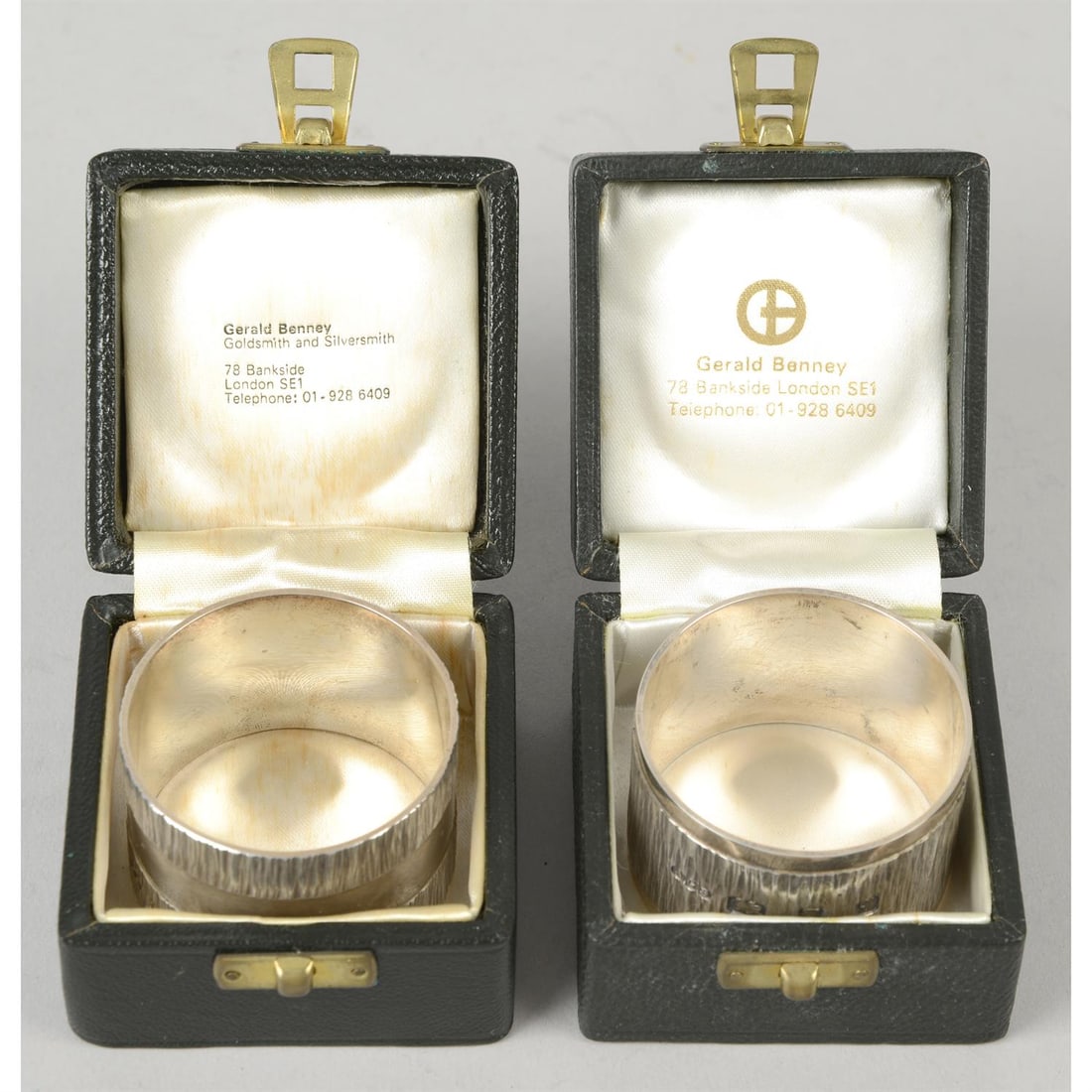 Two similar silver napkins by Gerald Benney.: Two similar silver napkin rings by Gerald Benney, both of circular form with textured band detail. Hallmarked London 1971 and 1972. Diameter 1.75" (4.5cm), weight 2.95 ozt (91.8 grams). Each in a blac