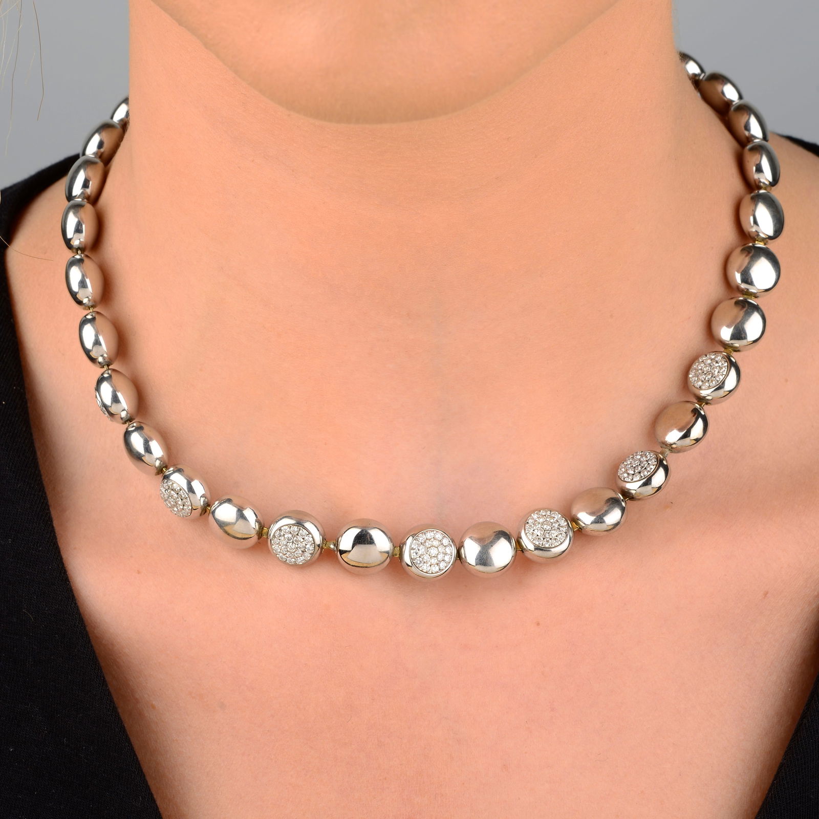 An 18ct gold pavÃ©-set diamond and polished disc link bracelet, by Chimento.Estimated total diamond: An 18ct gold pavÃ©-set diamond and polished disc link bracelet, by Chimento.Estimated total diamond weight 2.30cts, G-H colour, VS clarity.Hallmarks for Birmingham. Length 43.4cms. 43.9gms.