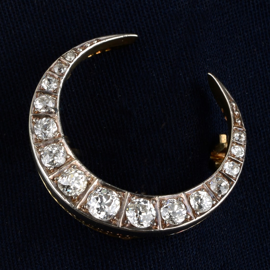 A late Victorian silver and gold old-cut diamond crescent moon brooch.Estimated diamond weight (1 of 4)