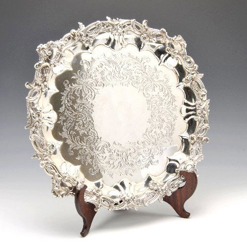 Victorian silver salver by Edward & John Barnard.: Victorian silver salver of shaped circular form, the rim in high relief with scrolling open work acanthus leafs with floral details, the body with conforming engraving and raised above four bracket fe
