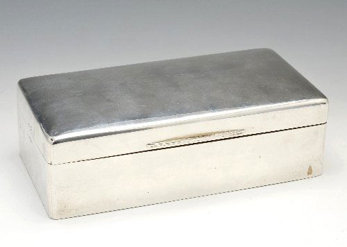 A 1920's silver mounted cigarette box.: A 1920's silver mounted cigarette box of plain rectangular form, opening to reveal a compartmentalised wooden interior. Hallmarked Walker & Hall 1923. Length measuring 7 inches (18 cm).