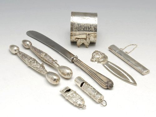 A selection of modern silver novelties.: A selection of modern silver novelties, to include an early twentieth century silver-handled knife, three needle cases, two whistles, a llama napkin ring and a bookmark. Knife hallmarked John Biggin,