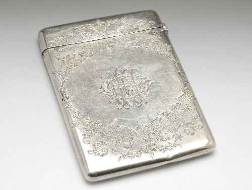Victorian florally engraved card case, London 1882: Victorian silver card case of plain rectangular form, the front engraved with a tied floral bouquet of thistles and chrysanthemums, the reverse with conforming surround to the monogram. Hallmarked Lon