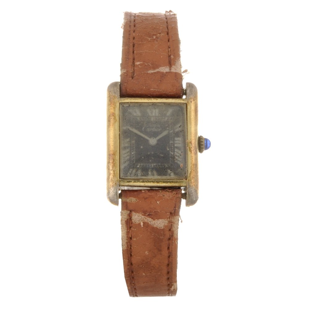 A gold plated silver manual wind lady's Must De Car: CARTIER - a gold plated silver manual wind lady's Must De Cartier wrist watch, the black dial with white Roman numeral hour markers, inner minute track, the H shaped case, stamped with common control 