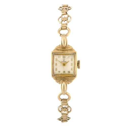 A 9ct gold manual wind lady's Tudor bracelet watch: TUDOR - a 9ct gold manual wind lady's bracelet watch, the silvered dial with gilt Arabic numerals, square shaped case, numbered 180541, fitted to a gold plated fancy link bracelet with folding clasp, 