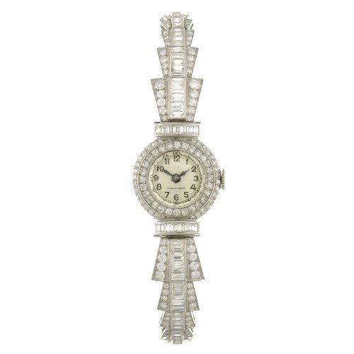 (201199630) A 9ct white gold manual wind lady's br: (201199630) A 9ct white gold manual wind lady's cocktail watch, the silvered dial with black Arabic numerals, outer minute track, circular shaped case set with diamonds, stainless steel back, fitted t