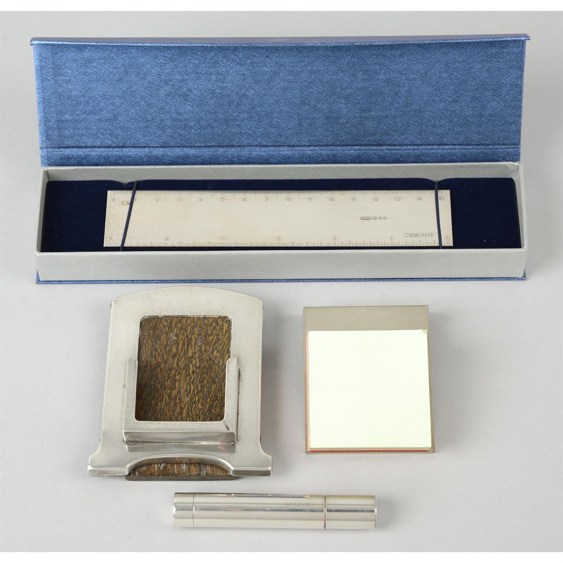 A 1920's silver mounted desk calendar, a modern silver 6" ruler, a post-it note holder & a small: A 1920's silver mounted desk calendar (missing month inserts), of shaped form with easel back support, hallmarked